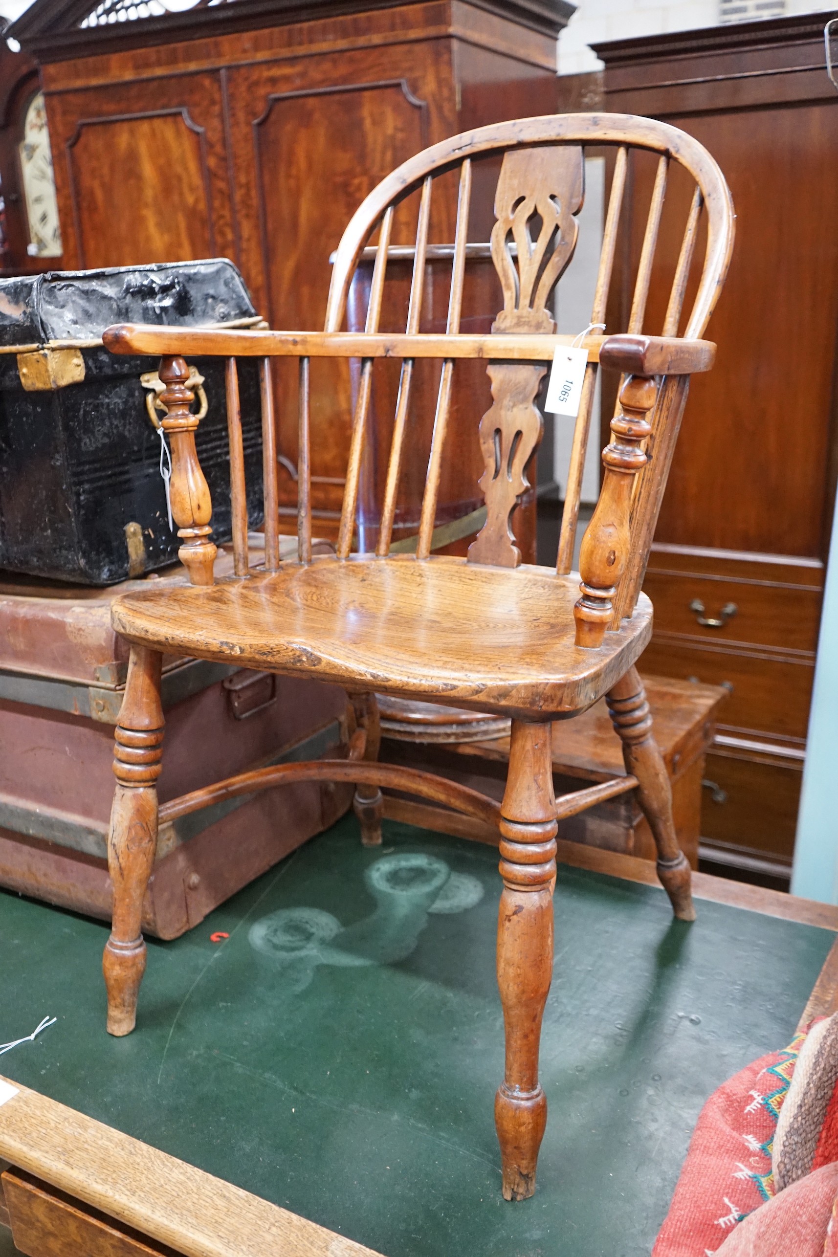 A Victorian yew and elm Windsor elbow chair, with crinoline stretcher, width 53cm, depth 44cm, height 90cm